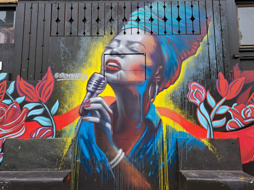 A street art mural of a singer