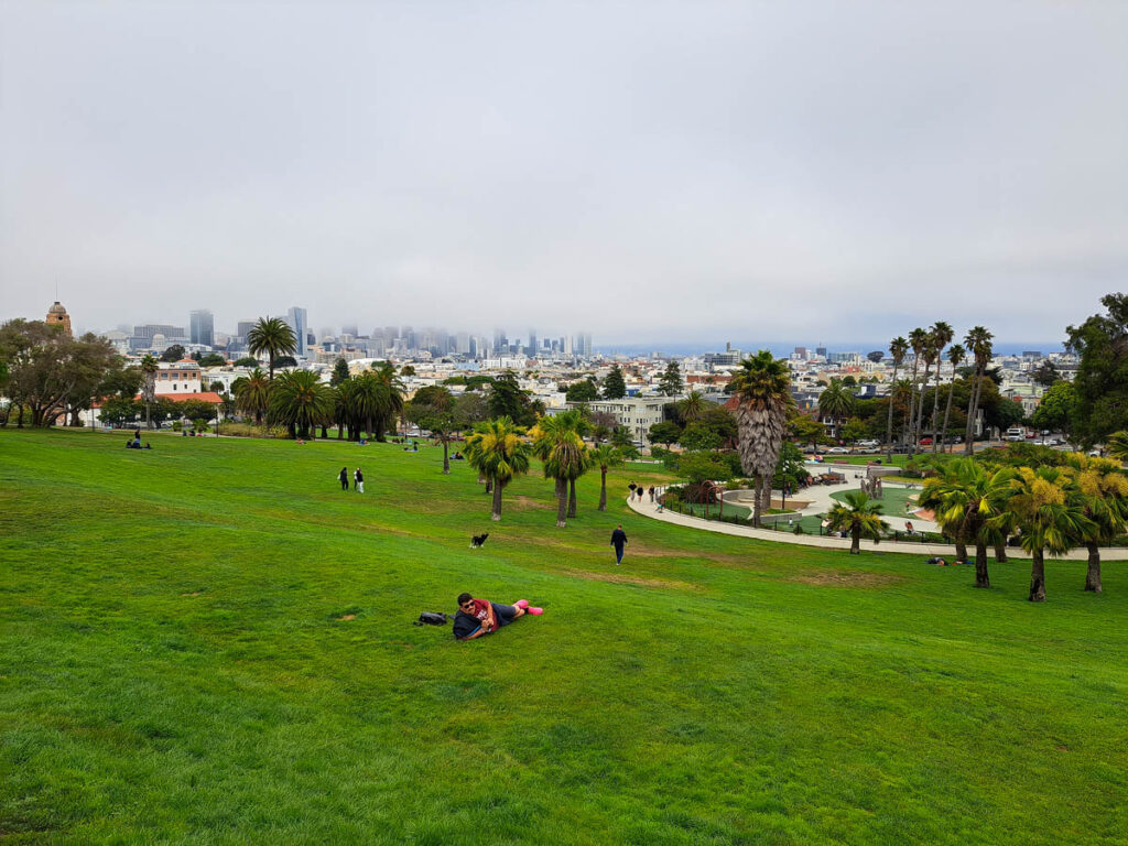 A view of downtown San Francisco covered in fog from Mission Delores Park