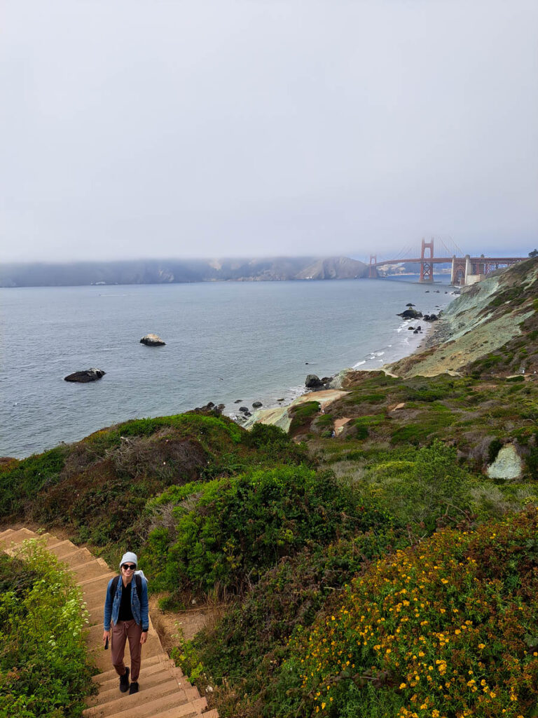 A woman with the Golden Gate bridge in the background, encased in fog