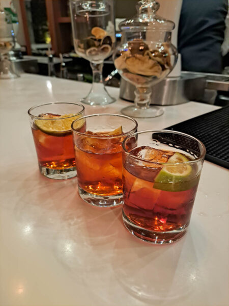 Three negroni drinks sitting on a bar at an all-inclusive resort in Puerto Plata, Dominican Republic