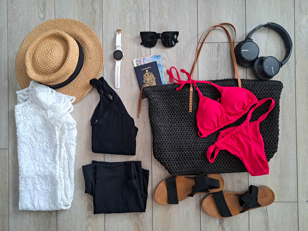 Clothing and necessities ready to pack for a tropical vacation.