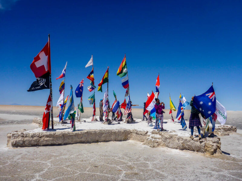 Flags of countries around the world standing in the middle of the Salar de Uyuni or Salt Flats in Bolivia