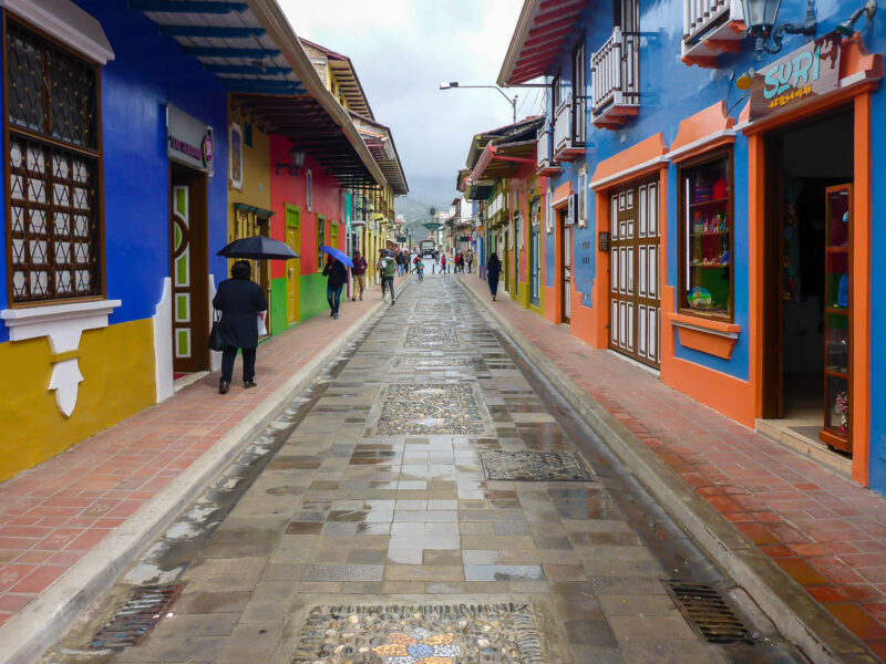 A narrow street with colorful buildings on either side in Loja, Ecuador