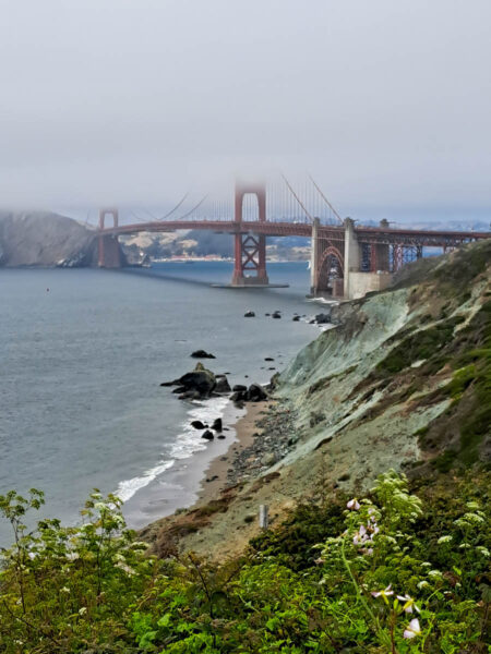 The San Francisco Strait with the Golden Gate Bridge half covered in fog