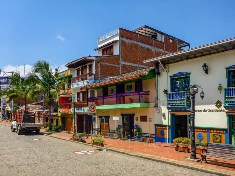 Colorful streetside shops, restaurants, and a bank in Guatapé, Colombia