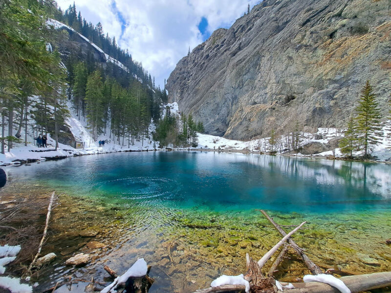 Turquoise colored Grassi Lakes nestled between two snow-capped Rocky Mountains