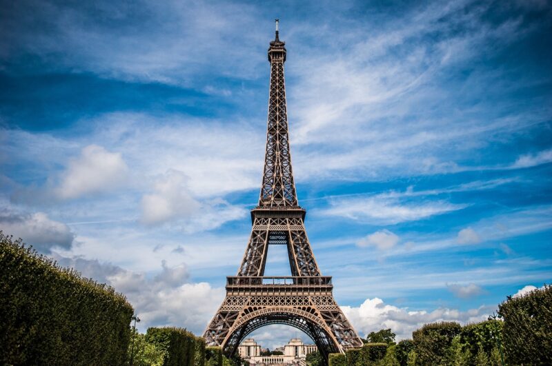 Eiffel Tower in Paris, France with blue skies and wispy clouds