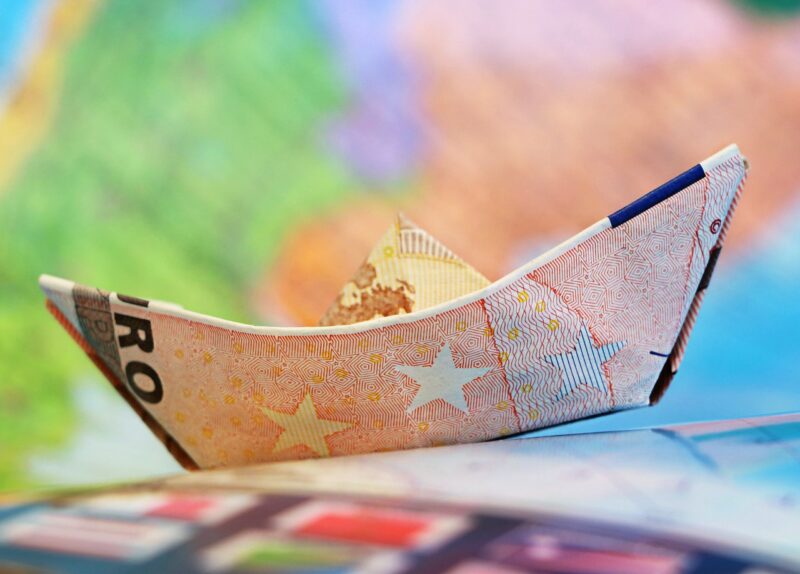 A 50 euro bank note folded into a small origami boat