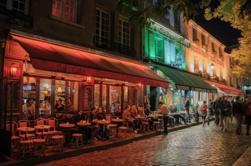 Restaurants in Paris at night lit up by streetlights