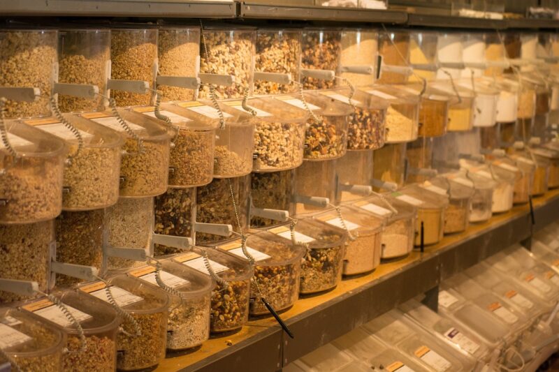 Bulk bins of spices, granola, and more lined up in three rows