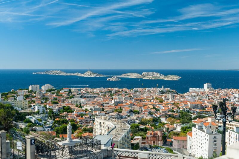 Aerial view of Marseille from the city looking towards the port, the Mediterranean Sea, Chateau d'If and city buildings.