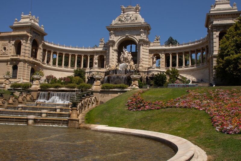 Palais Longchamp in Marseille with fountains and gardens in the front.